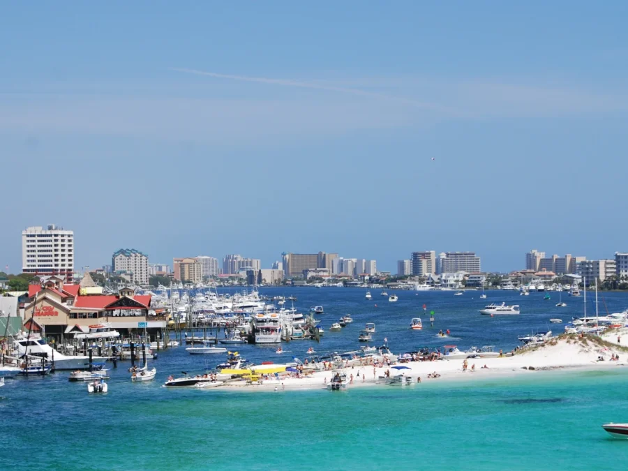 Boats, waterfront buildings and the shoreline around Destin Harbor